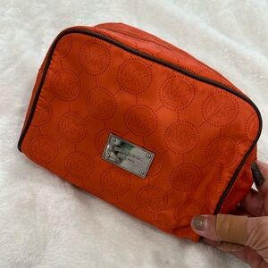Michael kors cosmetic bag color orange.